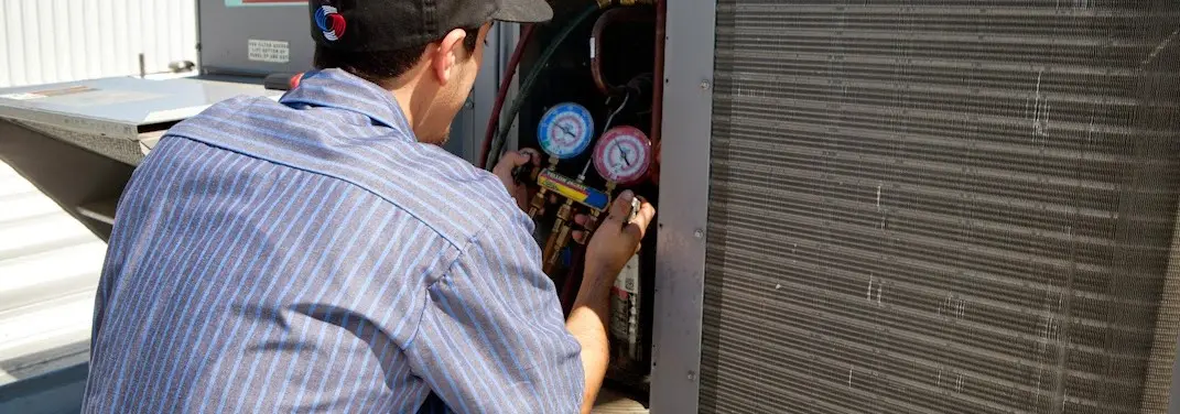 HVAC technician servicing a condenser unit in Citrus Hills